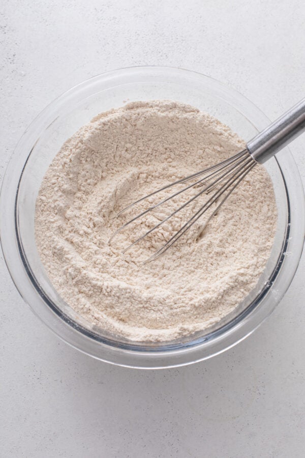 dry ingredients for caramel apple cookies whisked in a glass bowl.