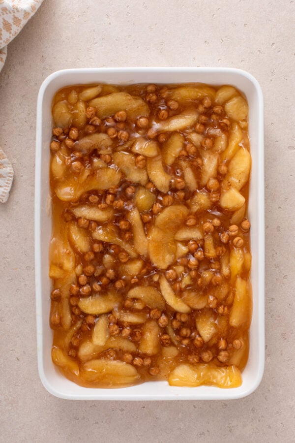 Filling for caramel apple dump cake in a white baking dish.