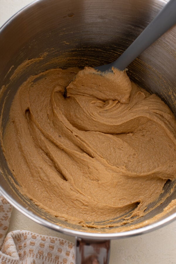 Wet ingredients for cookie butter cookies mixed in a stand mixer bowl.