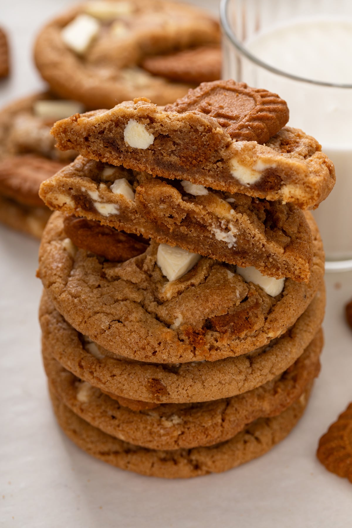 Stack of cookie butter cookies with a halved cookie perched on top to show the chewy middle.