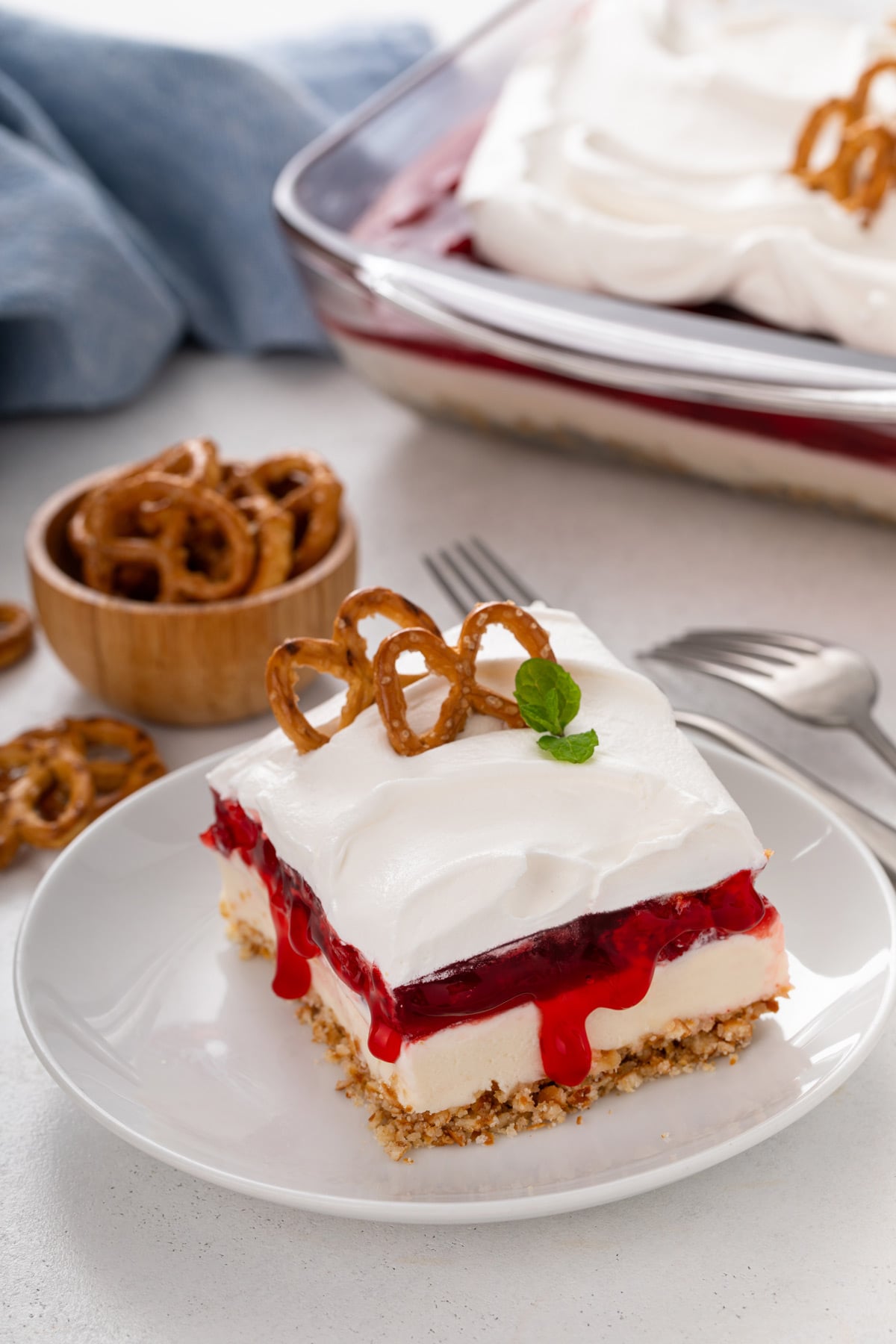 Plated slice of cherry cheesecake pretzel salad.