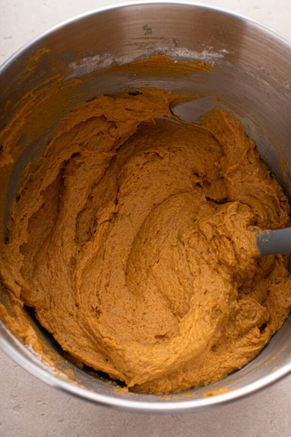 Batter for pumpkin snack cake mixed in a metal bowl.
