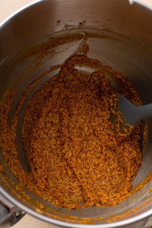 Wet ingredients for pumpkin snack cake mixed in a metal bowl.