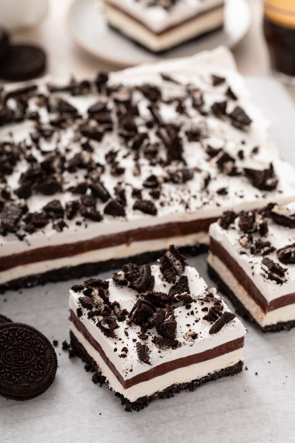 Layered chocolate pudding dessert removed from the pan, with slices cut from it.