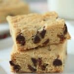 Close up image of two white chocolate blondies stacked together on a plate