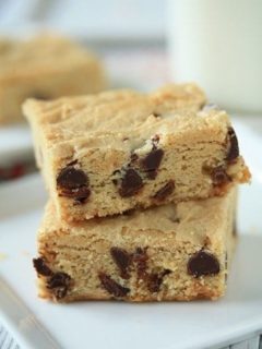 Close up image of two white chocolate blondies stacked together on a plate