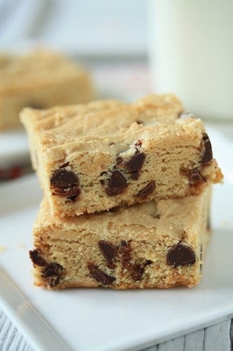 Close up image of two white chocolate blondies stacked together on a plate